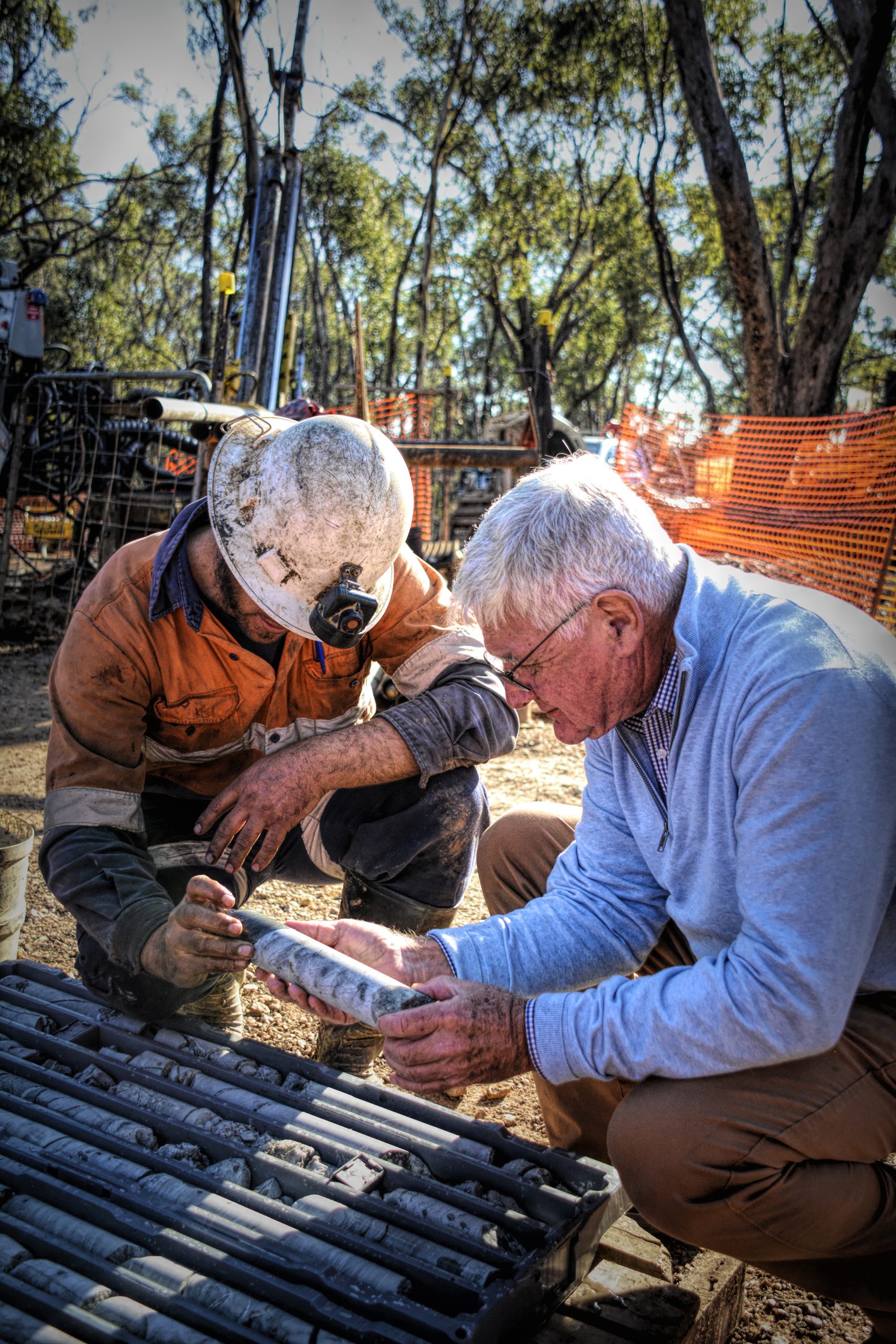 Dick Sandner inspects diamond drill core with a member of WGL's drill team.